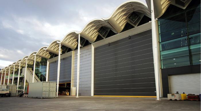 Shipyard doors form a durable barrier against coastal weather with high winds and corrosive conditions. With safe, sustainable, and efficient operation.